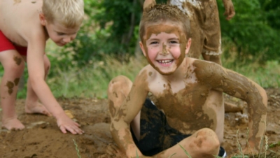 Boys playing in the mud.