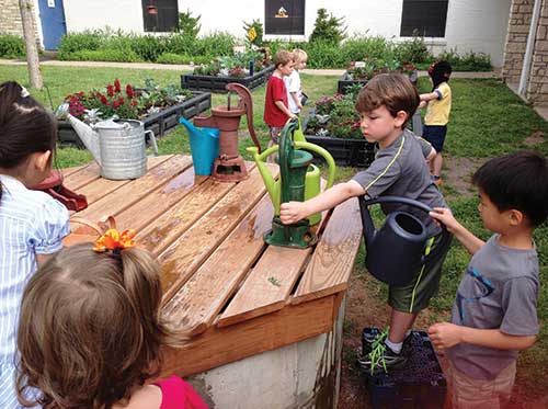 Children filling water buckets Children filling water buckets