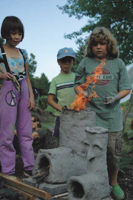 Children cooking over a fire Children cooking over a fire