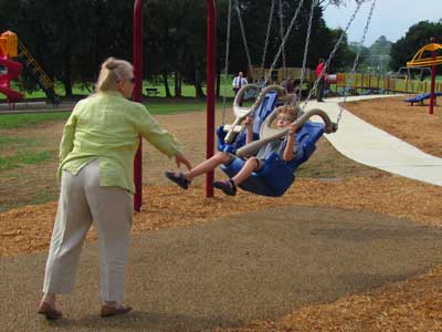 Grandmother with child in swing