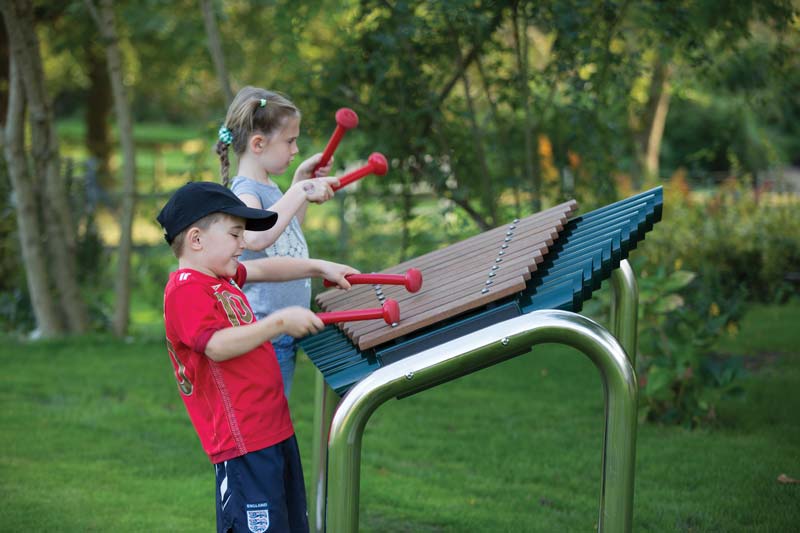 Kids playing on musical playground equipment Kids playing on musical playground equipment