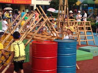 Kid with ladders and colorful barrels Kid with ladders and colorful barrels