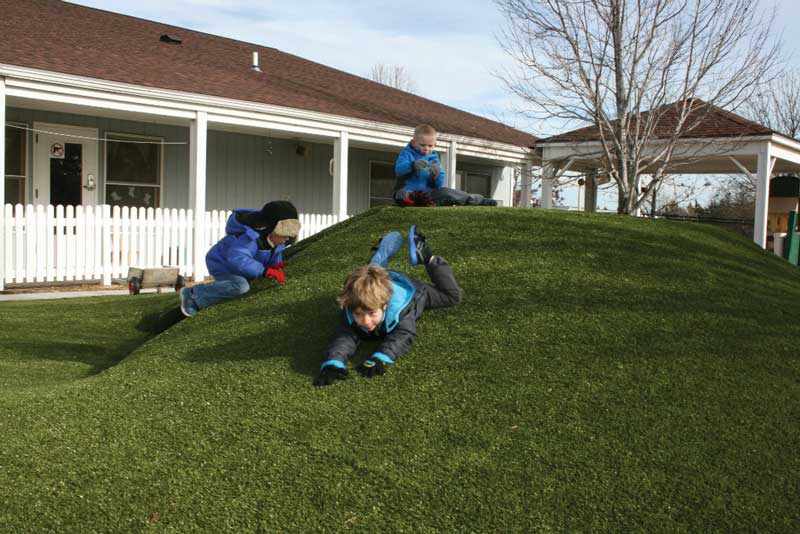 Kids can safely romp and roll around on soft synthetic grass. Security Benefit child care facility, Topeka, KS. Kids can safely romp and roll around on soft synthetic grass. Security Benefit child care facility, Topeka, KS.