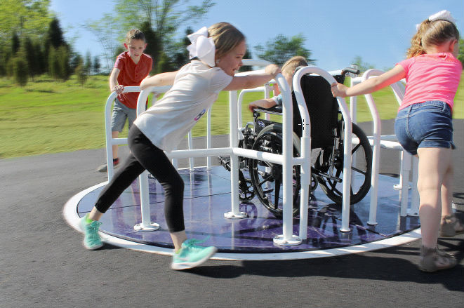 Children on a wheelchair accessible merry-go-round. Children on a wheelchair accessible merry-go-round.