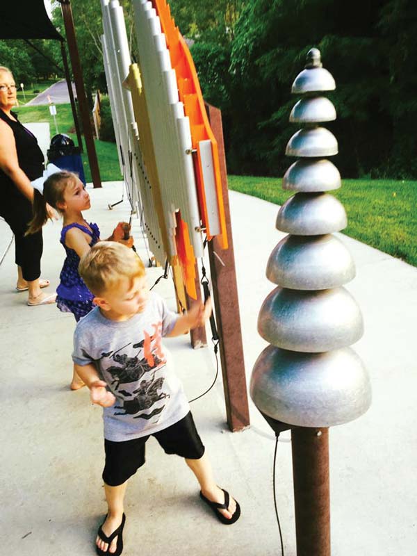 Kids playing on musical playground equipment Kids playing on musical playground equipment