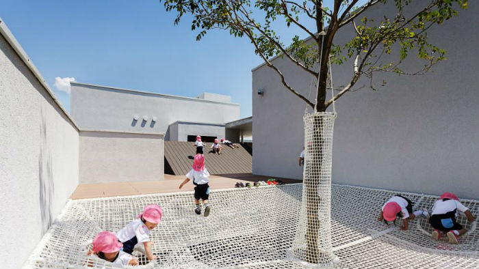 Children climb on nets in a nursery in Japan Children climb on nets in a nursery in Japan