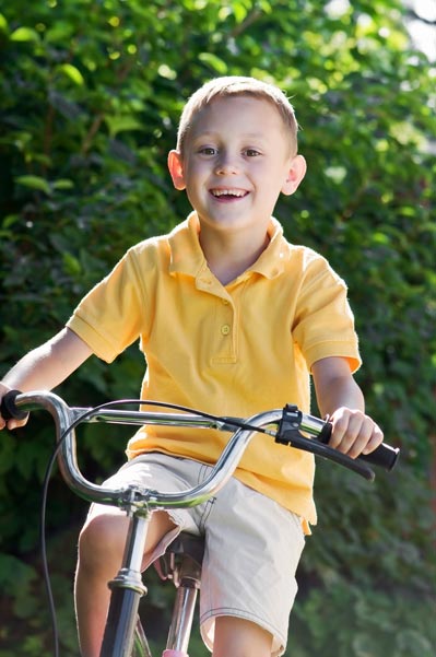 Young boy biking to school