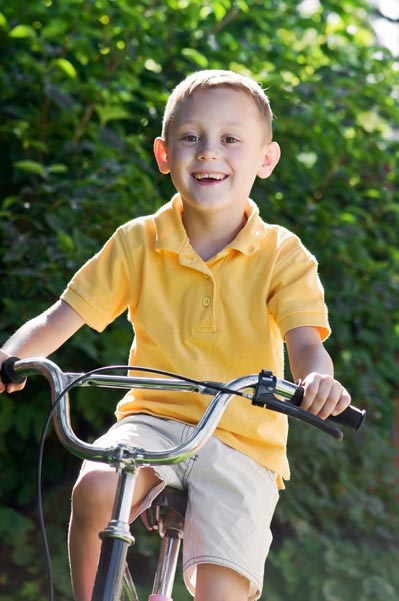 Young boy biking to school Young boy biking to school
