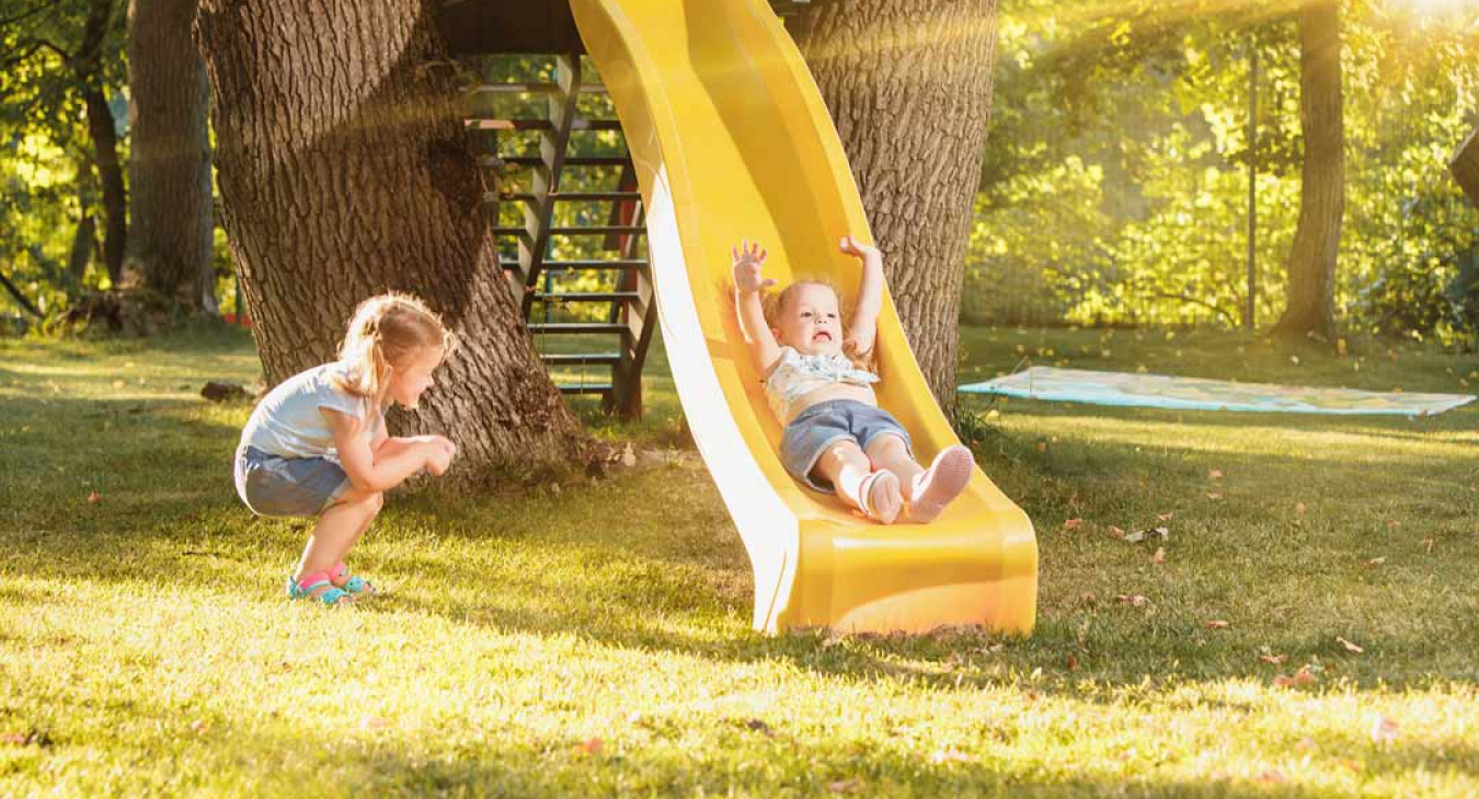 Child sliding on a backyard slide