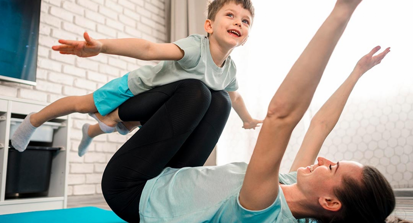 mother working out with her child on her legs