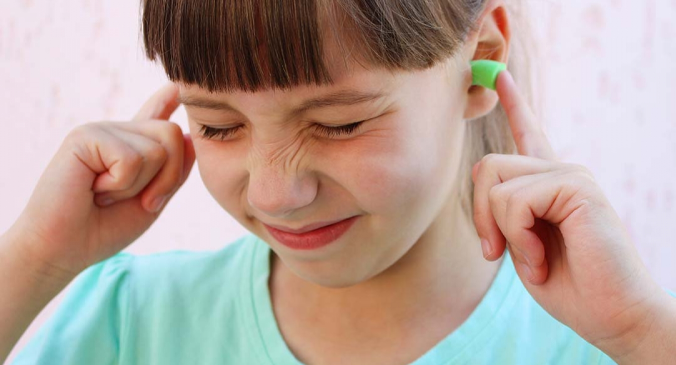 girl wearing ear plugs
