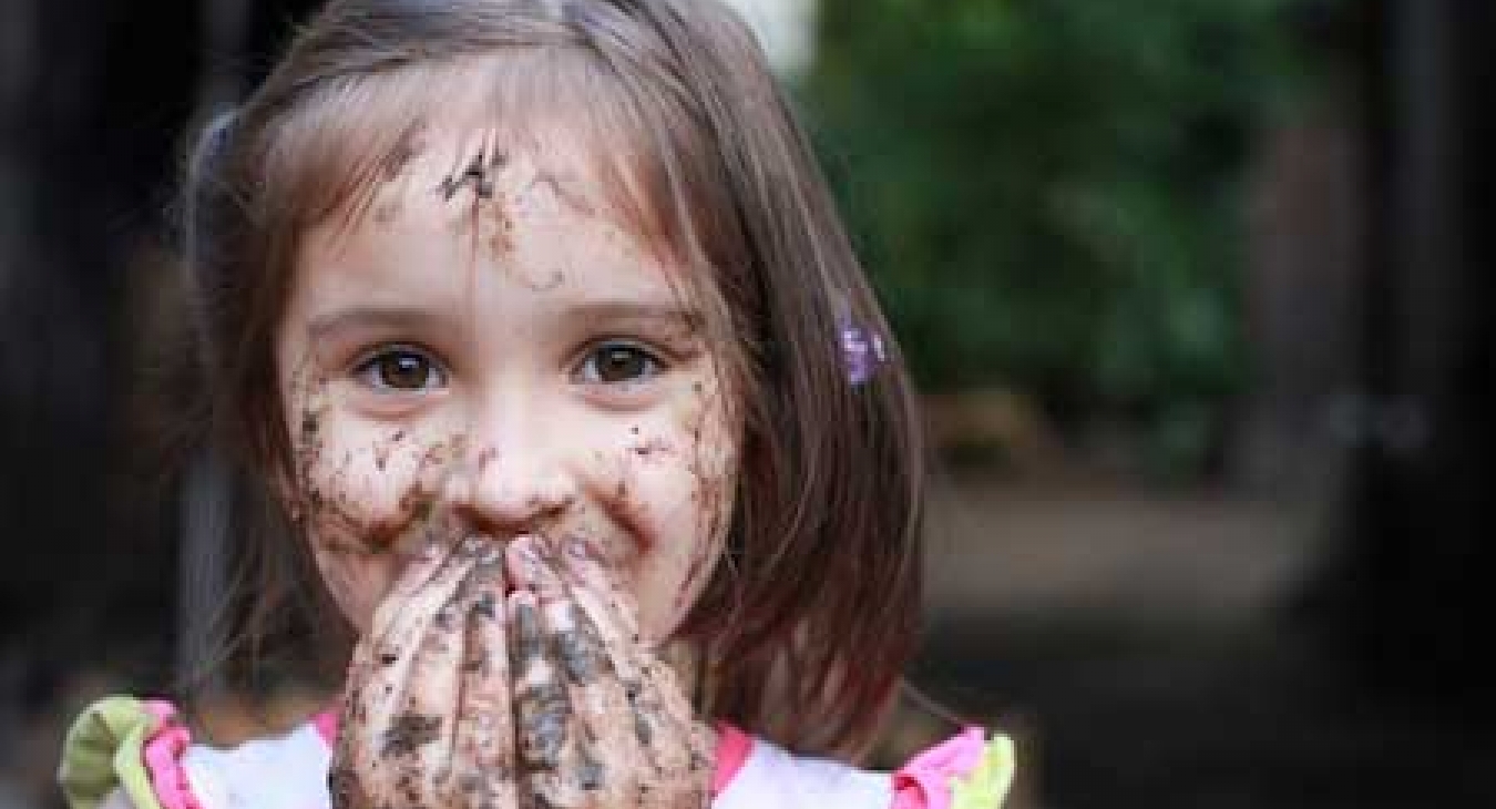 Girl playing with dirt.