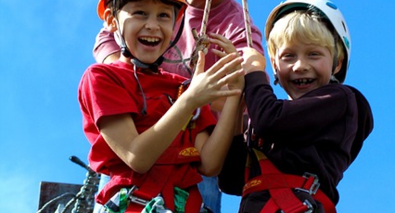 Kids excited to ride a zip line.