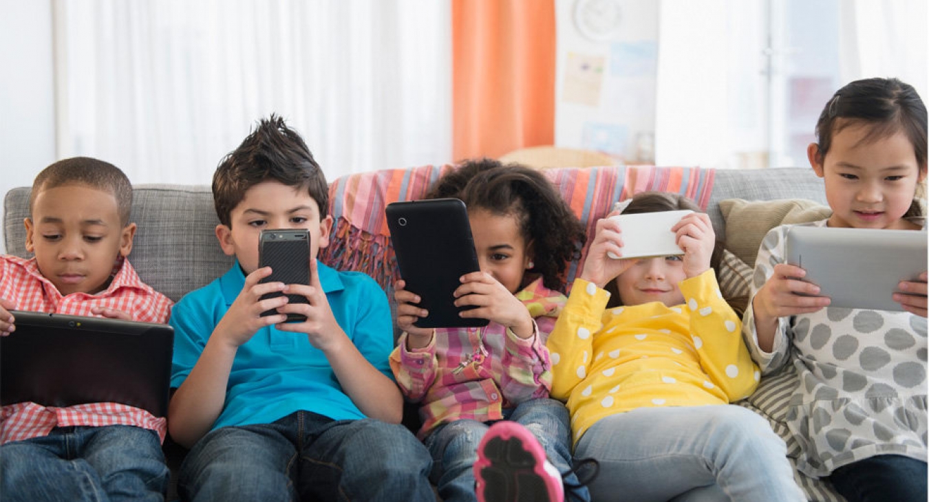 Children using smartphones and tablets.
