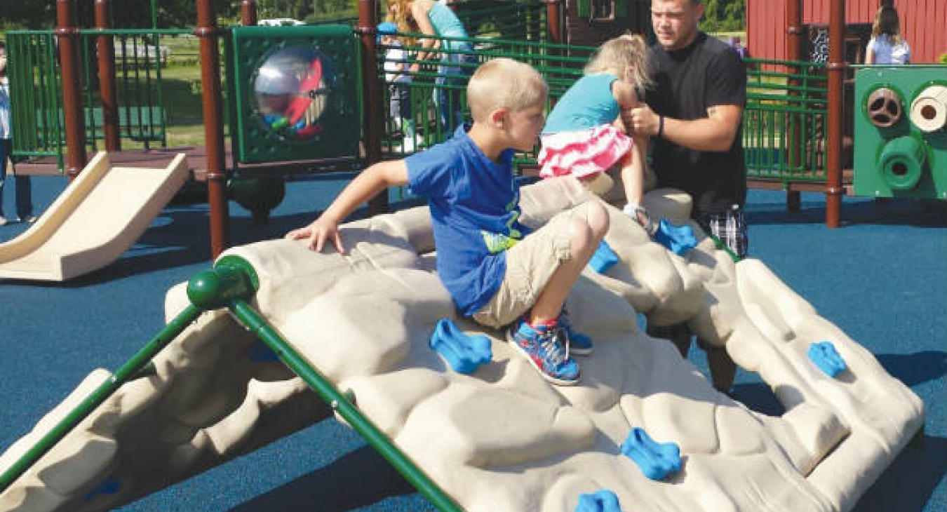 Children play on an inclusive playground