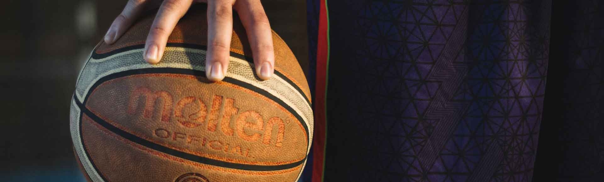 teen gripping a basketball